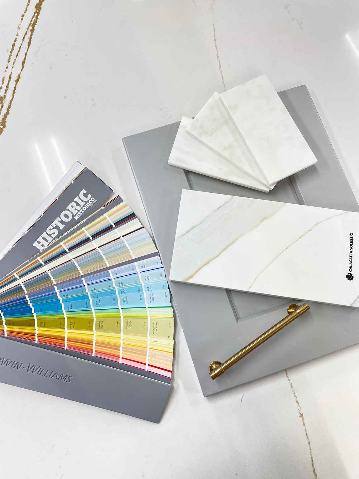 Kitchen with modern tile backsplash complementing countertops and cabinets.