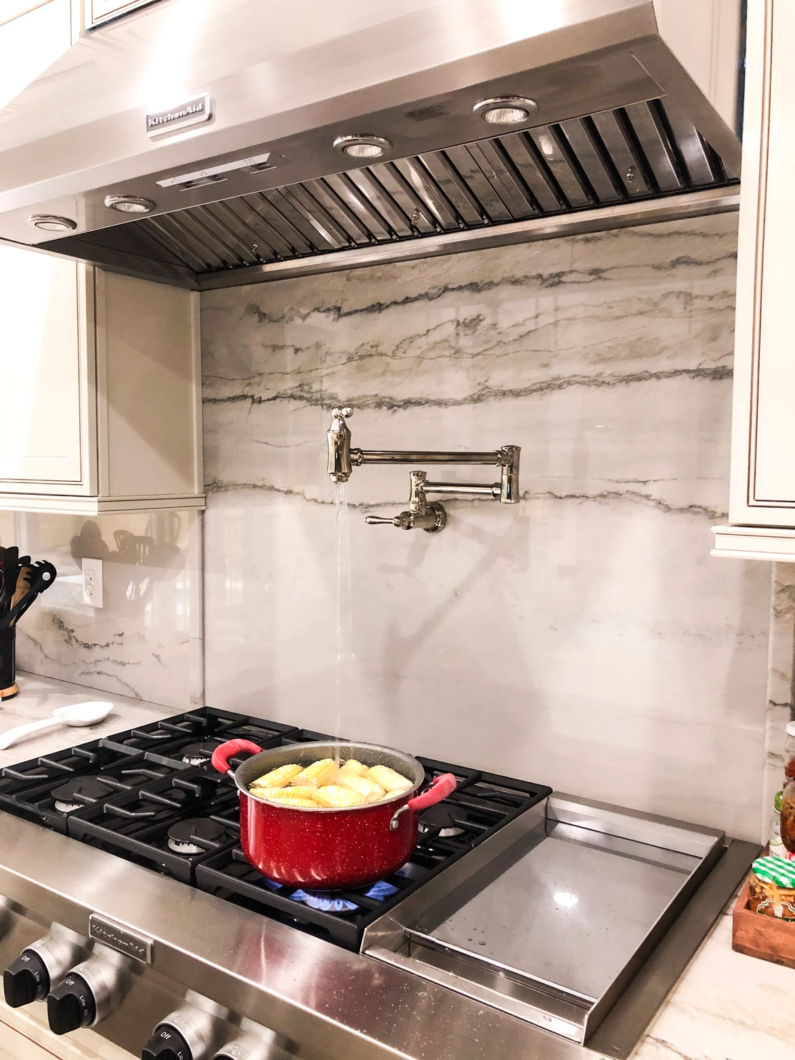 Kitchen showcasing a sophisticated backsplash design with both tile and stone elements.
